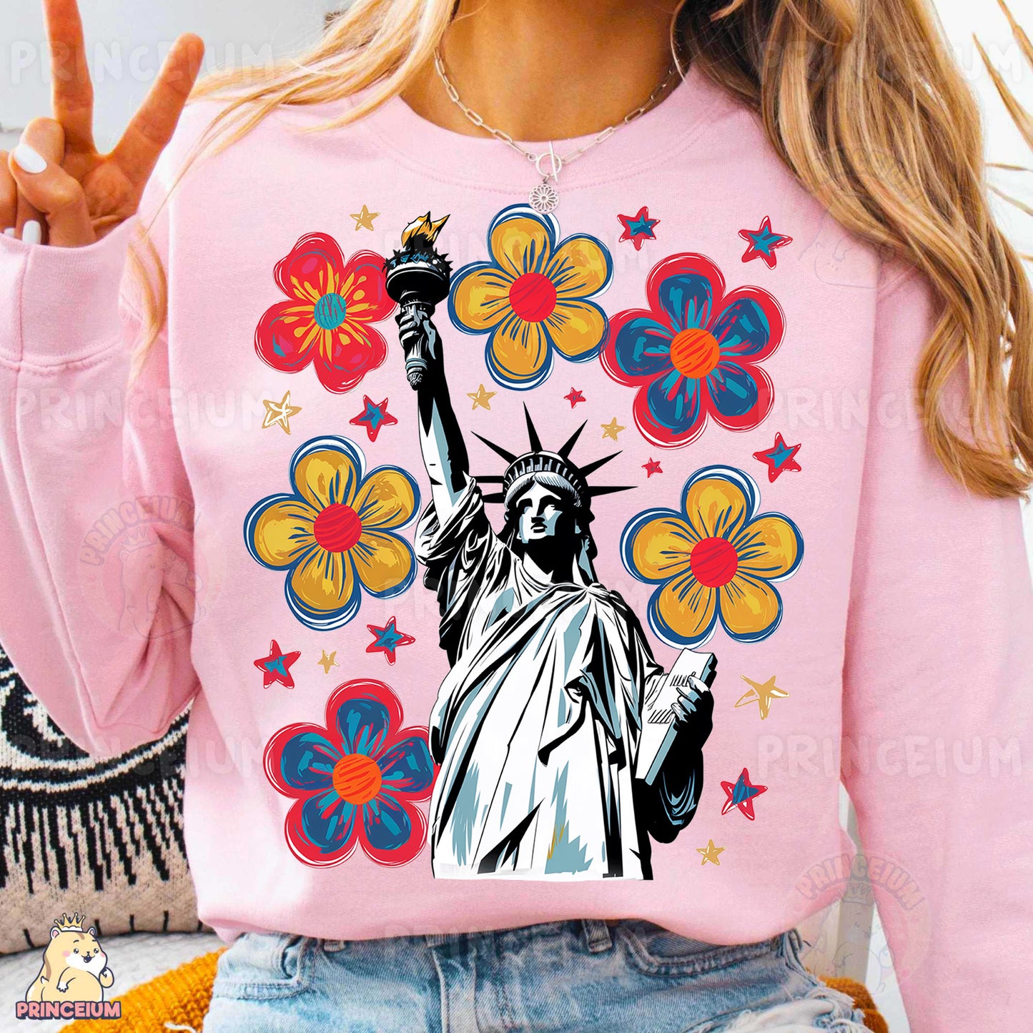 a woman wearing a pink sweatshirt with the statue of liberty on it