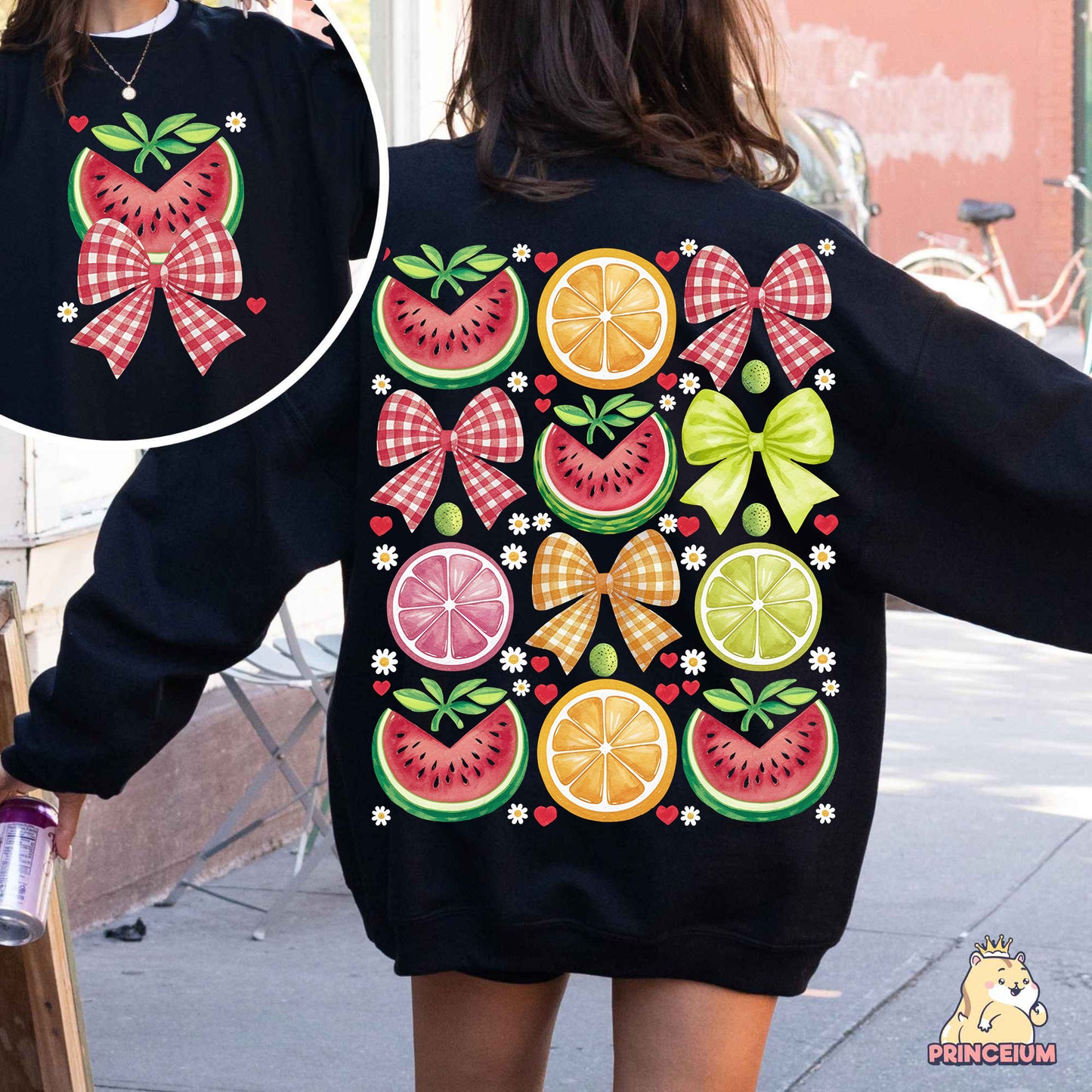 a woman wearing a black sweatshirt with fruit on it