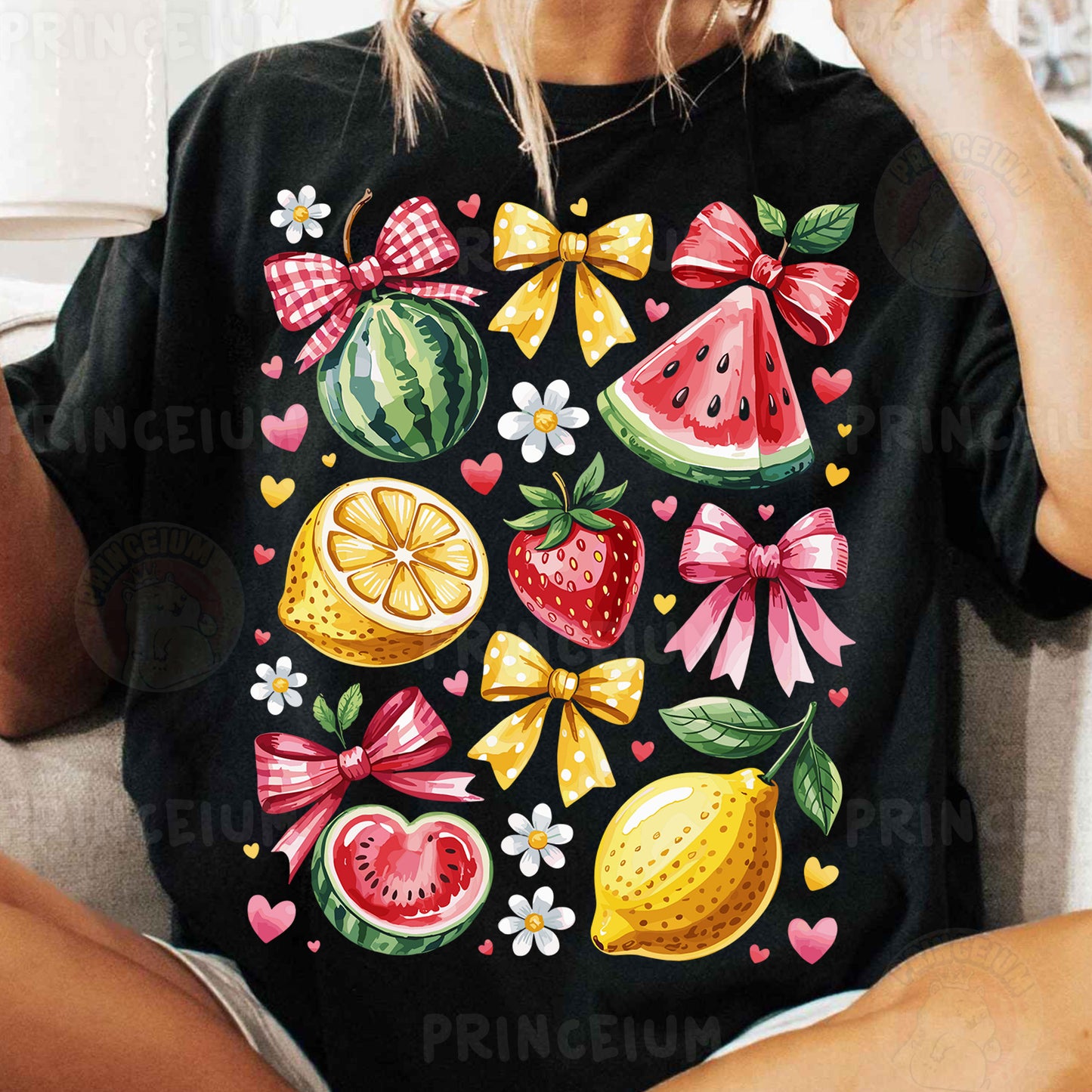 a woman sitting on a couch wearing a black shirt with fruit on it