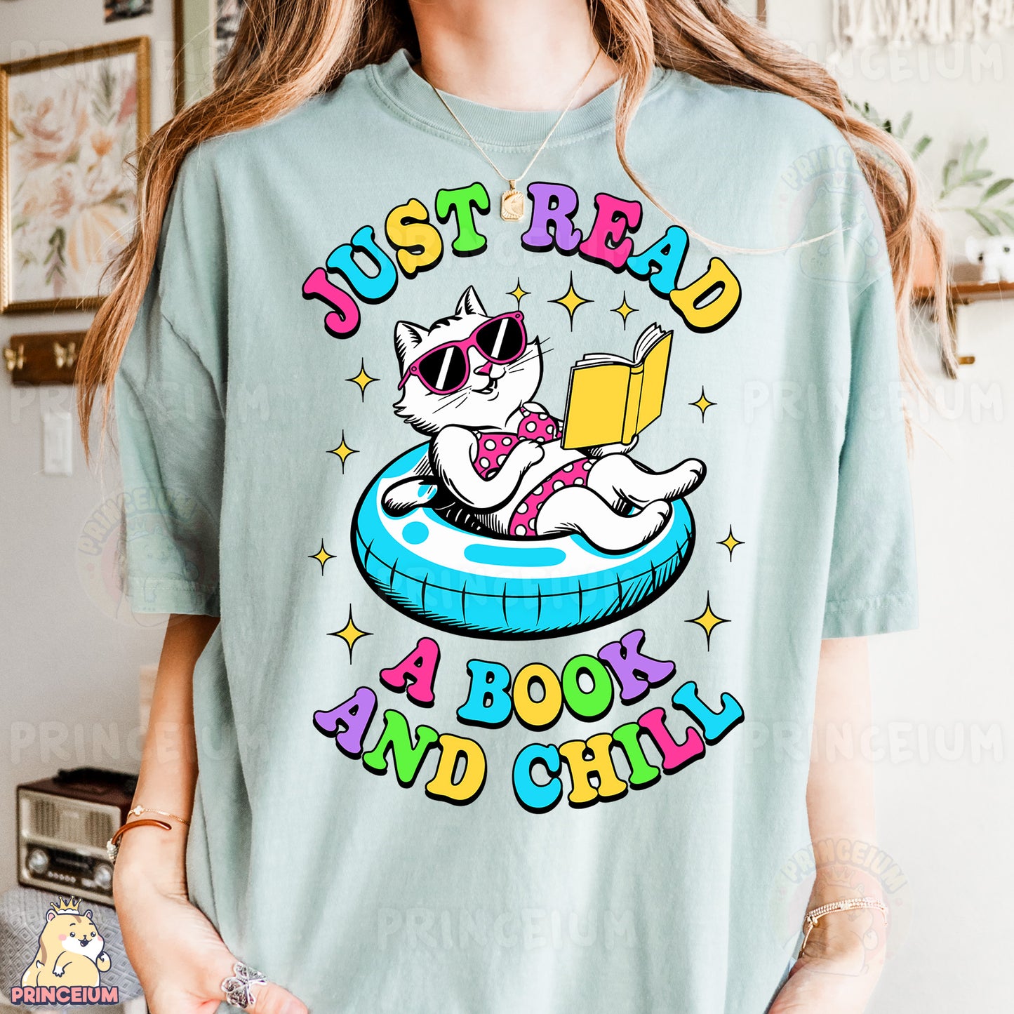 a woman wearing a t - shirt with a cat reading a book