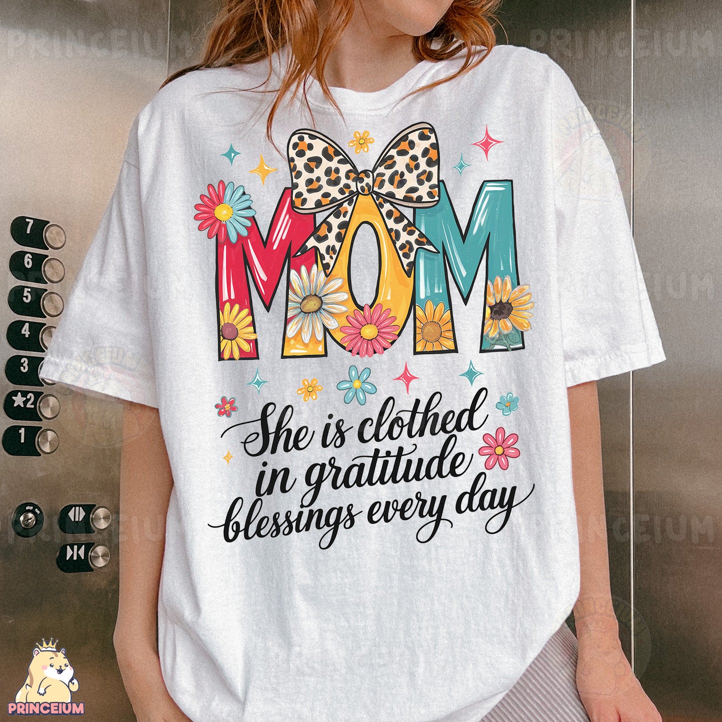 a woman wearing a t - shirt that says mom she is clothed in grati