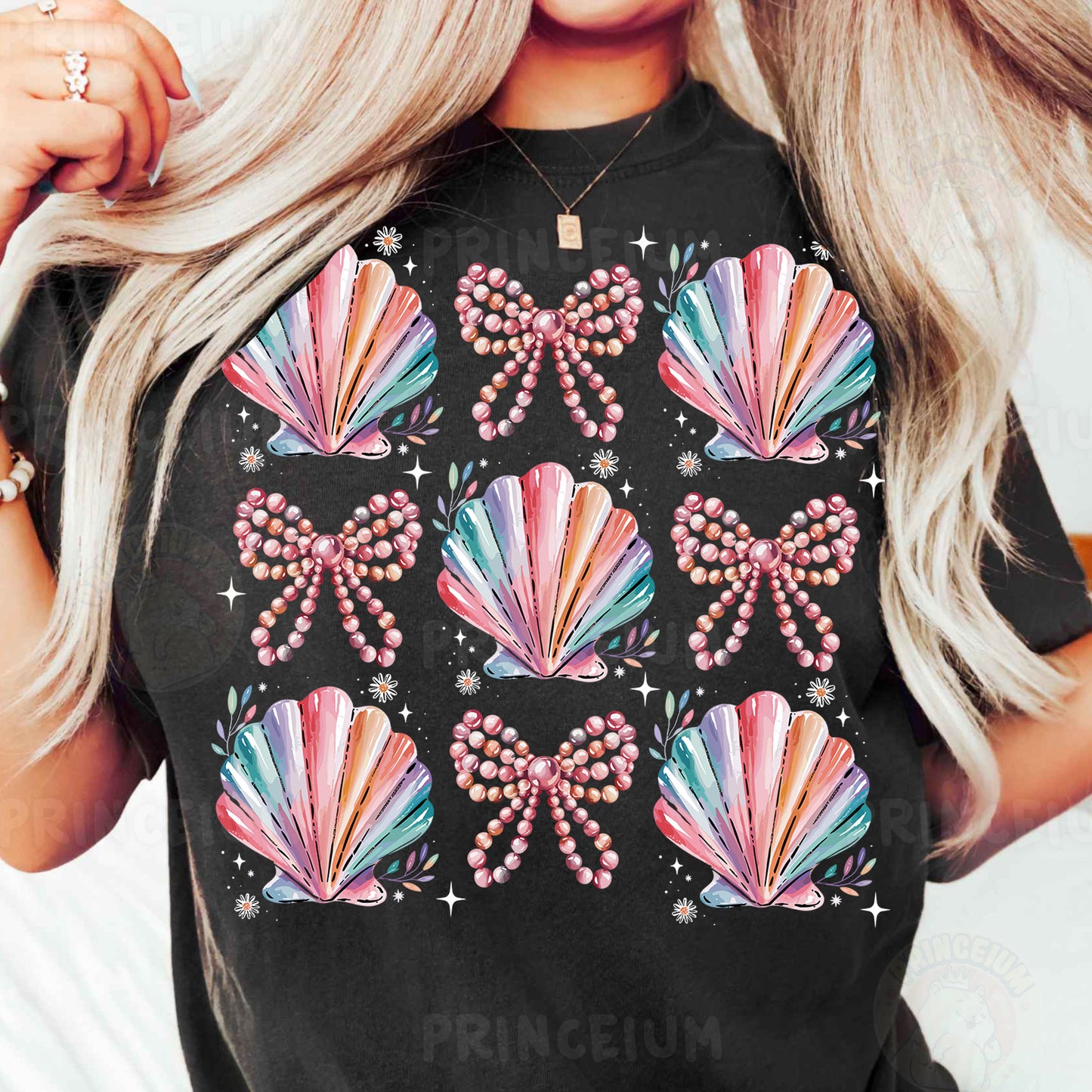 a woman with blonde hair wearing a black t - shirt with colorful seashells