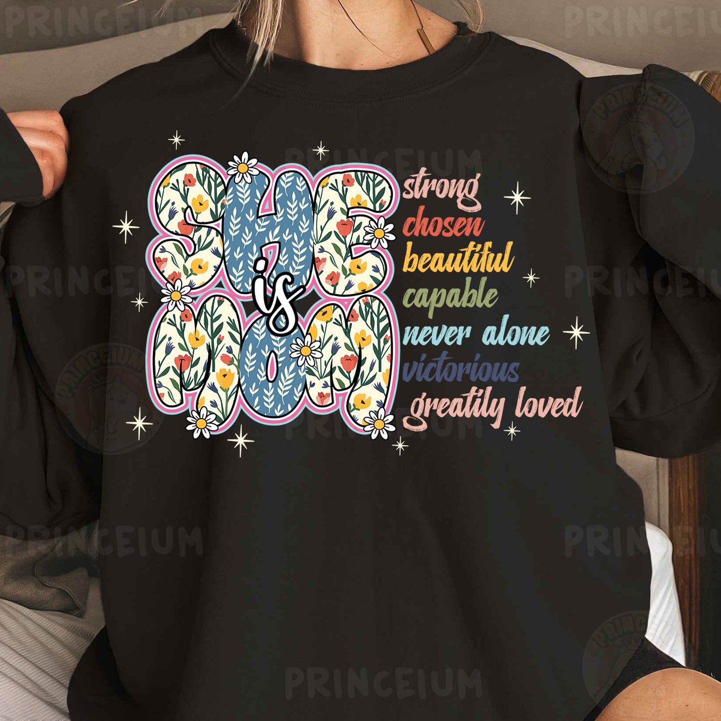 a woman wearing a black shirt with a flower design on it