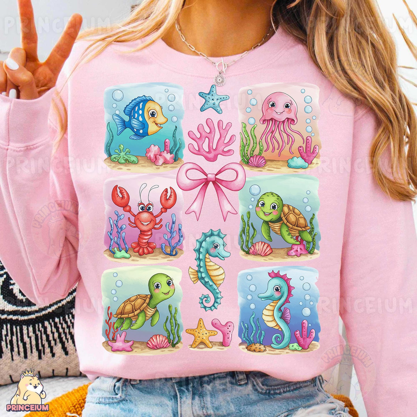 a woman wearing a pink sweater with sea animals on it