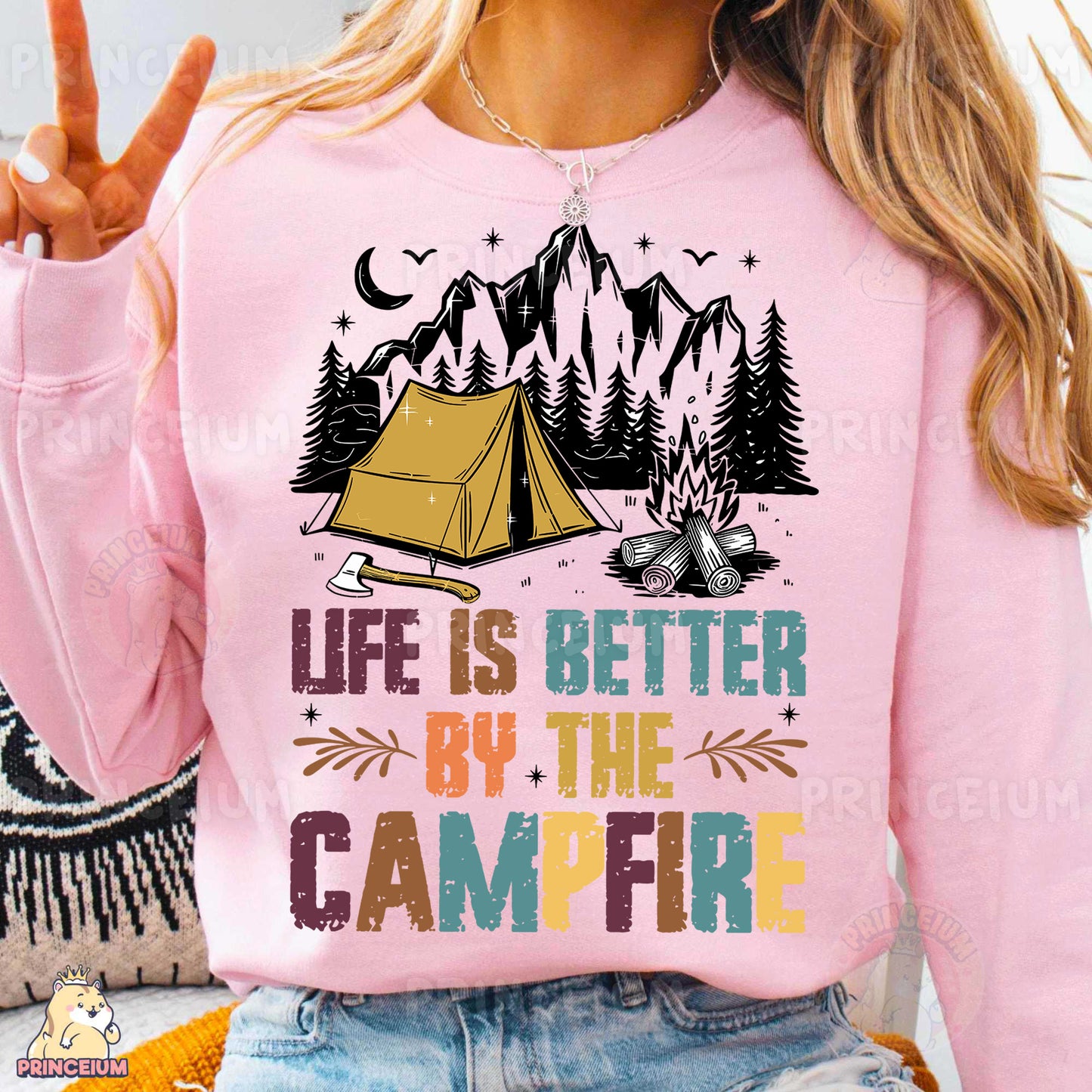 a woman wearing a pink sweatshirt with a tent on it