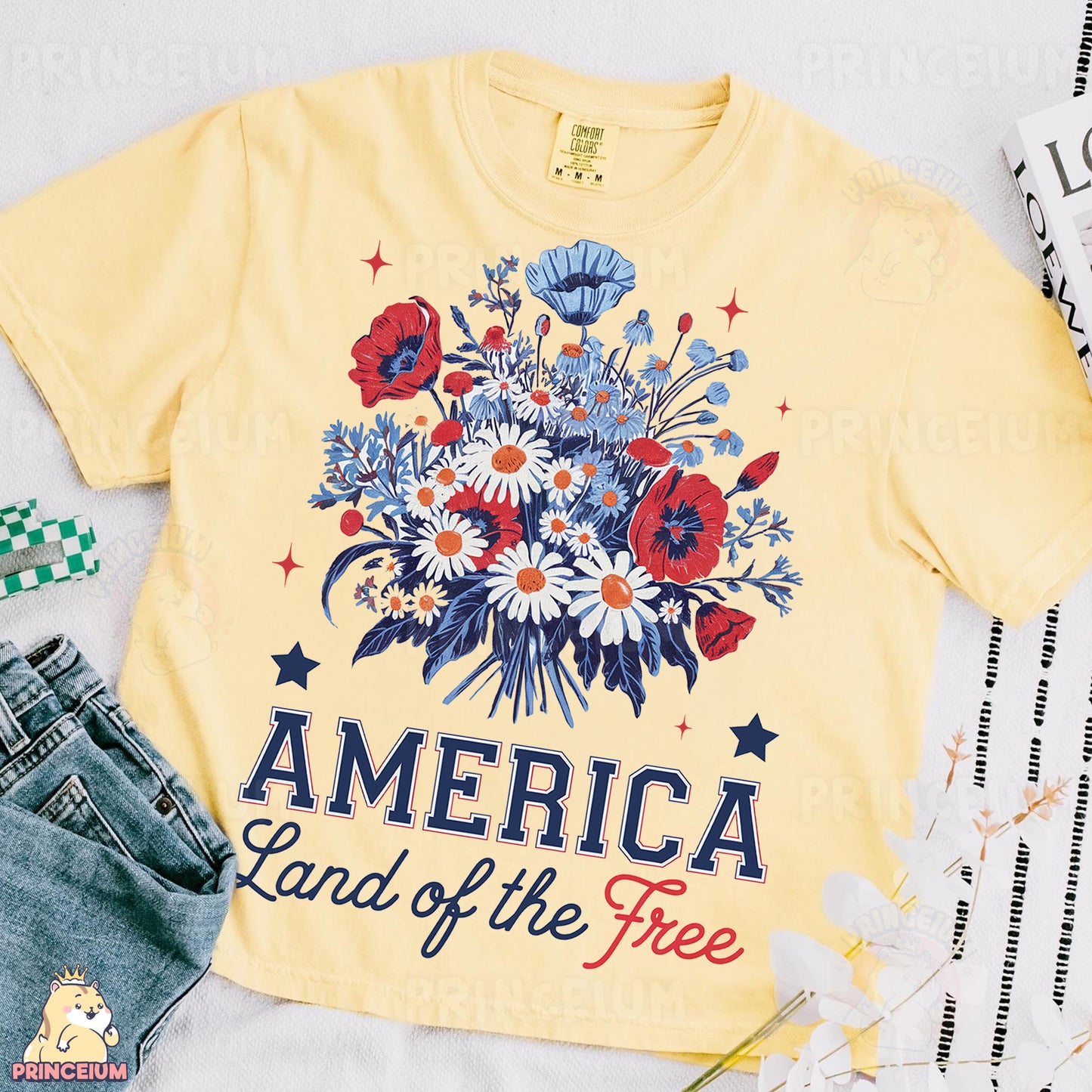 an american land of the free t - shirt next to a pair of jeans