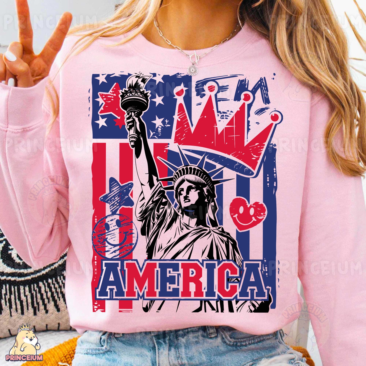 a woman wearing a pink sweatshirt with the statue of liberty on it
