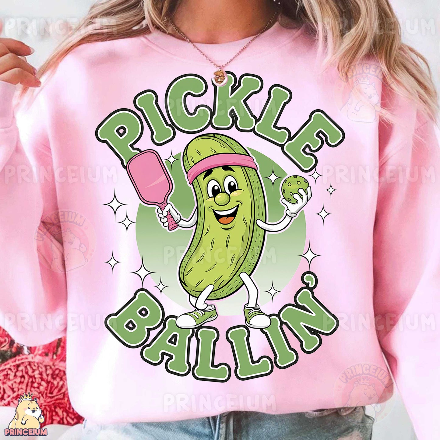 a woman wearing a pink pickle ball sweatshirt