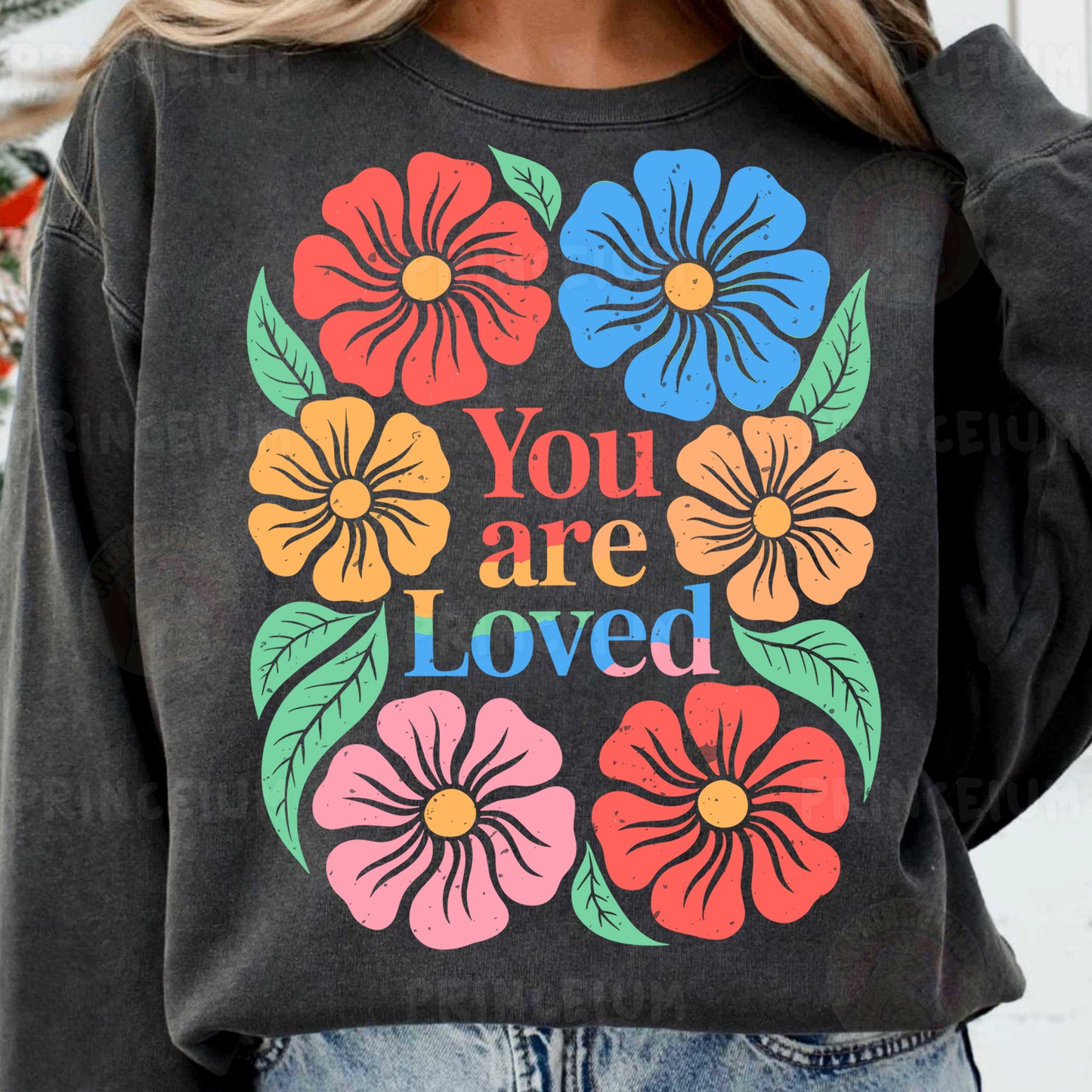 a woman wearing a sweatshirt that says you are loved