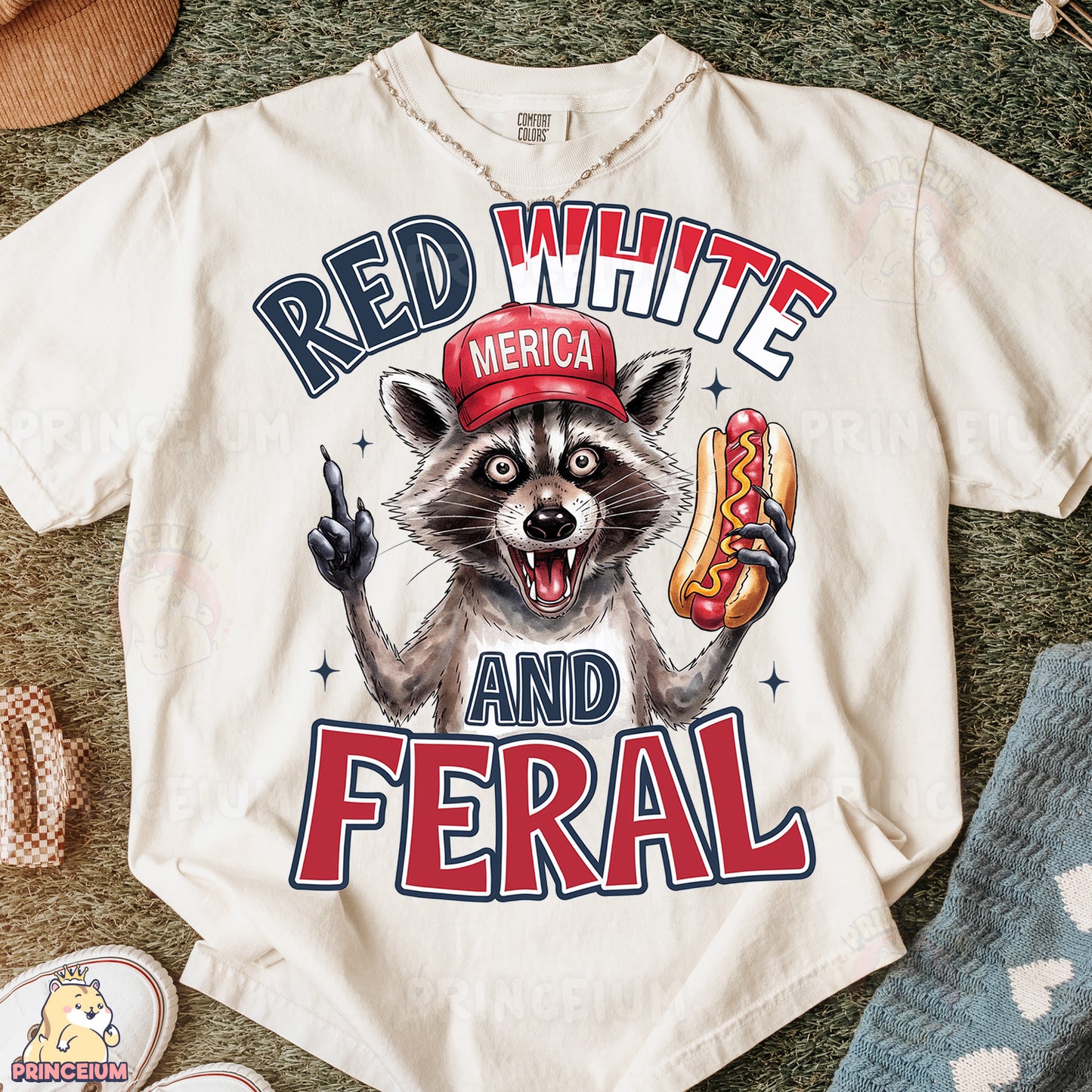 a white shirt with a raccoon wearing a red hat and holding a hot