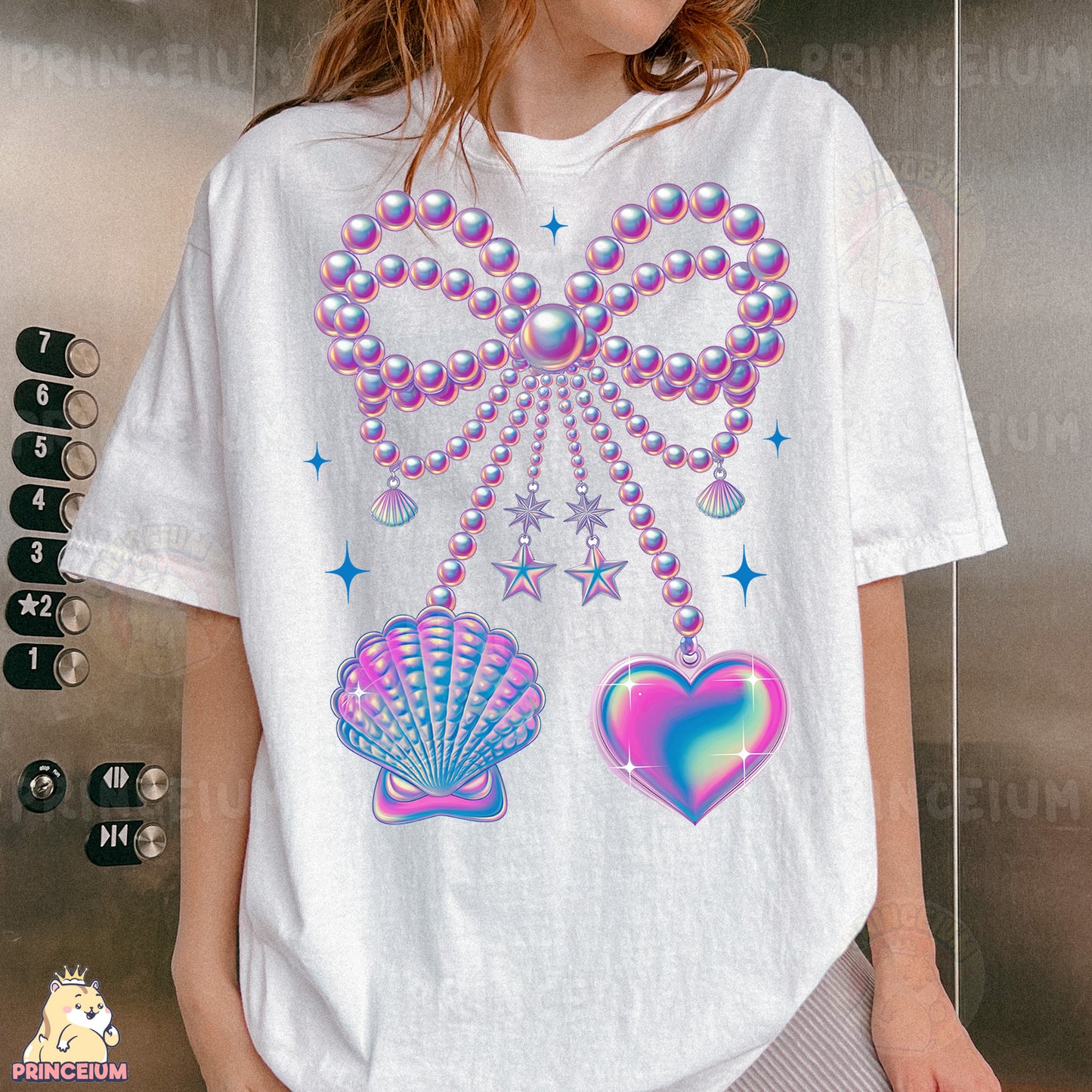 a woman wearing a t - shirt with a design of pearls and seashells