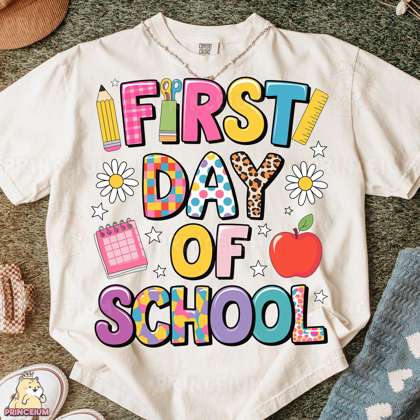 a t - shirt that says first day of school next to a pair of shoes