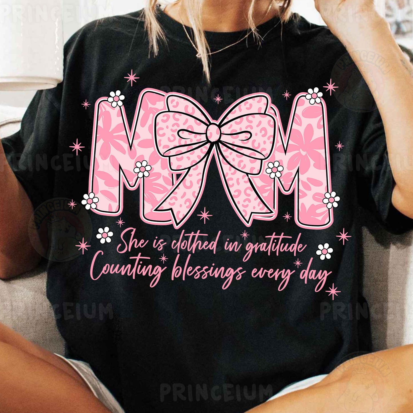 a woman sitting on a couch wearing a mom shirt