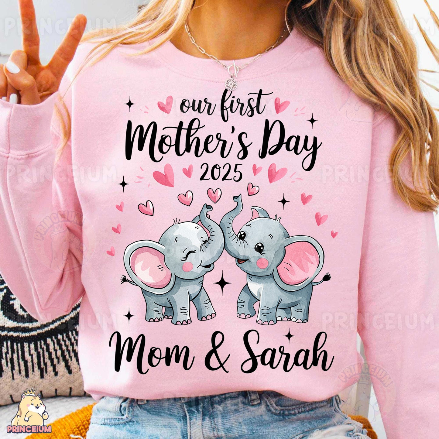 a woman wearing a pink sweater with two elephants on it