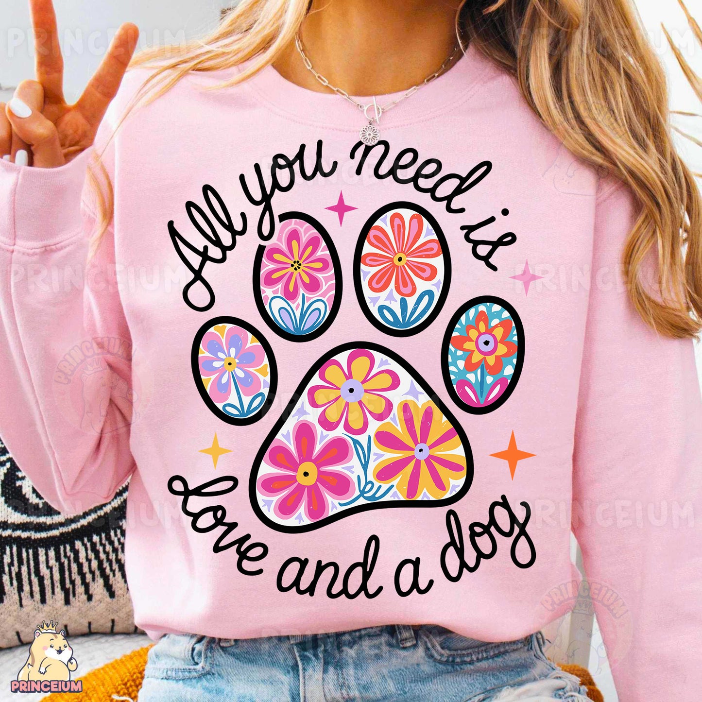 a woman wearing a pink shirt with a dog paw on it