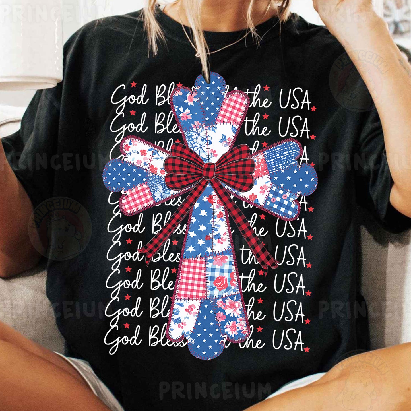 a woman sitting on a couch wearing a black shirt with red, white and blue