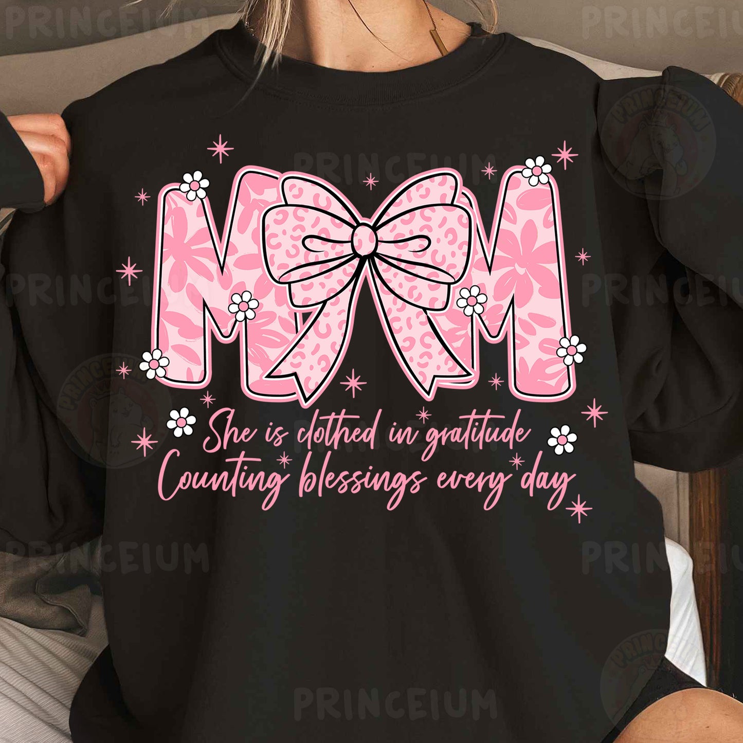 a woman wearing a black shirt with a pink bow