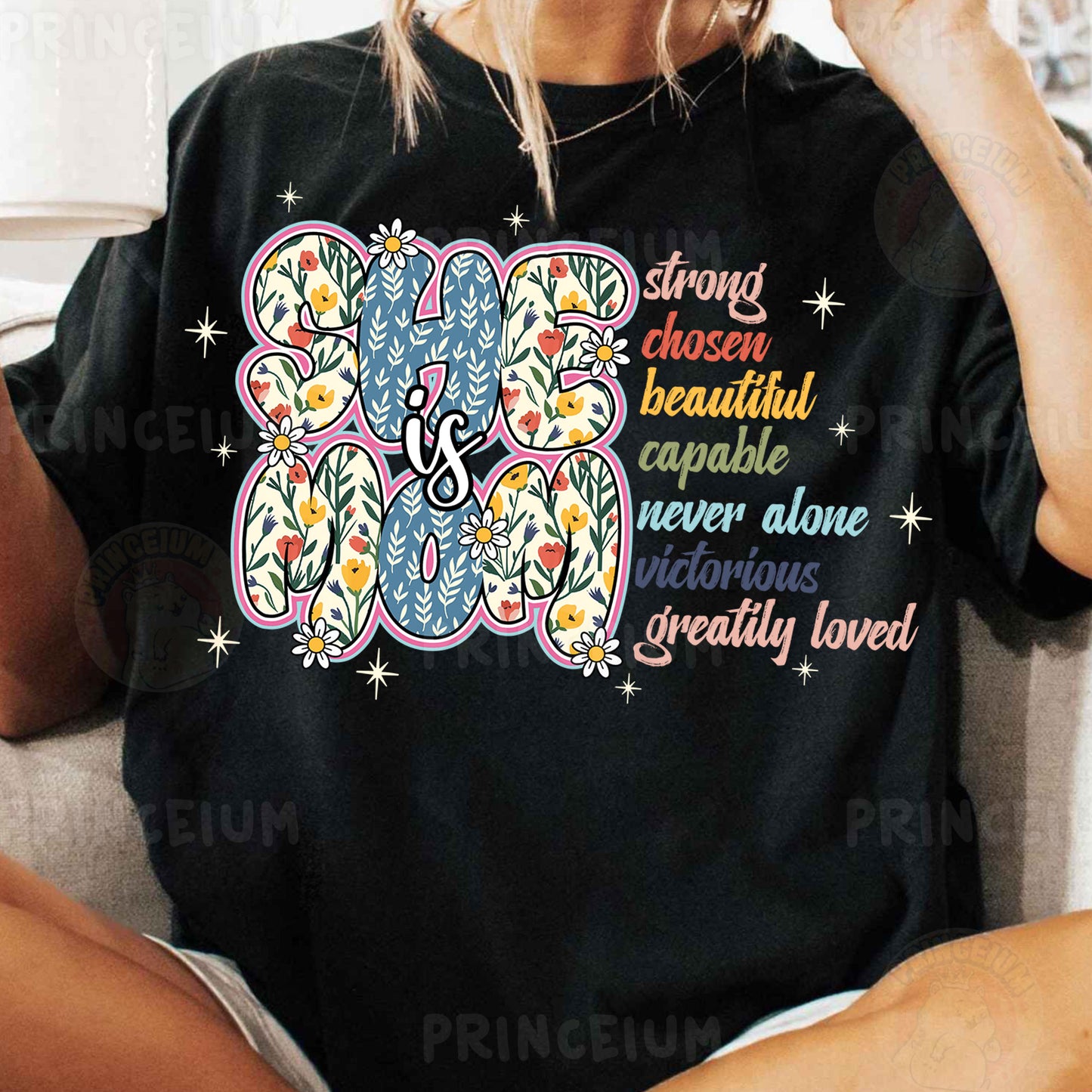 a woman sitting on a couch wearing a black shirt