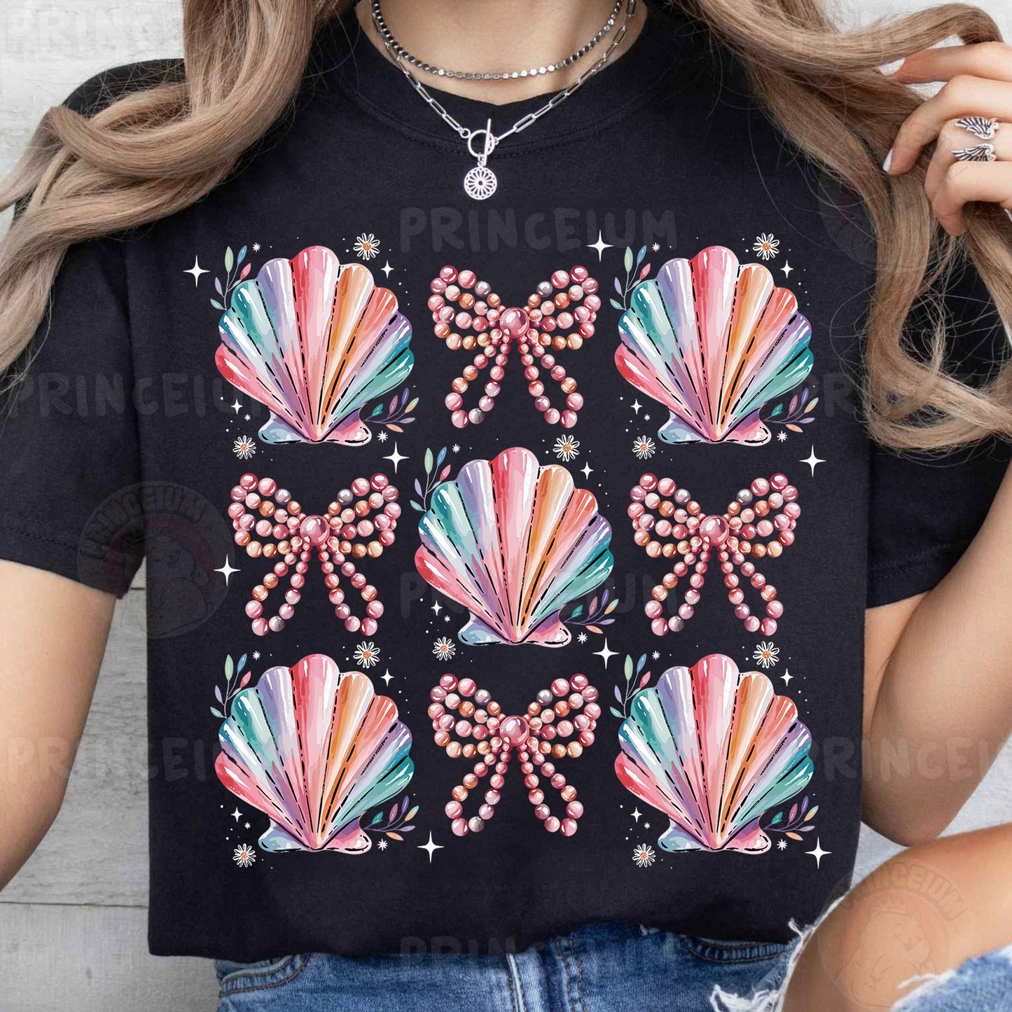 a woman wearing a black t - shirt with colorful seashells on it