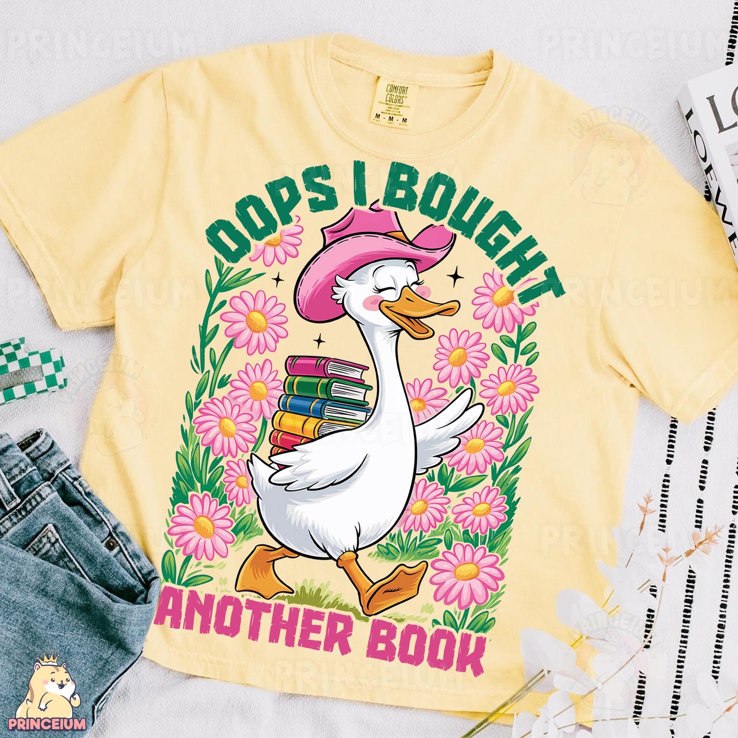 a yellow shirt with a duck wearing a pink hat