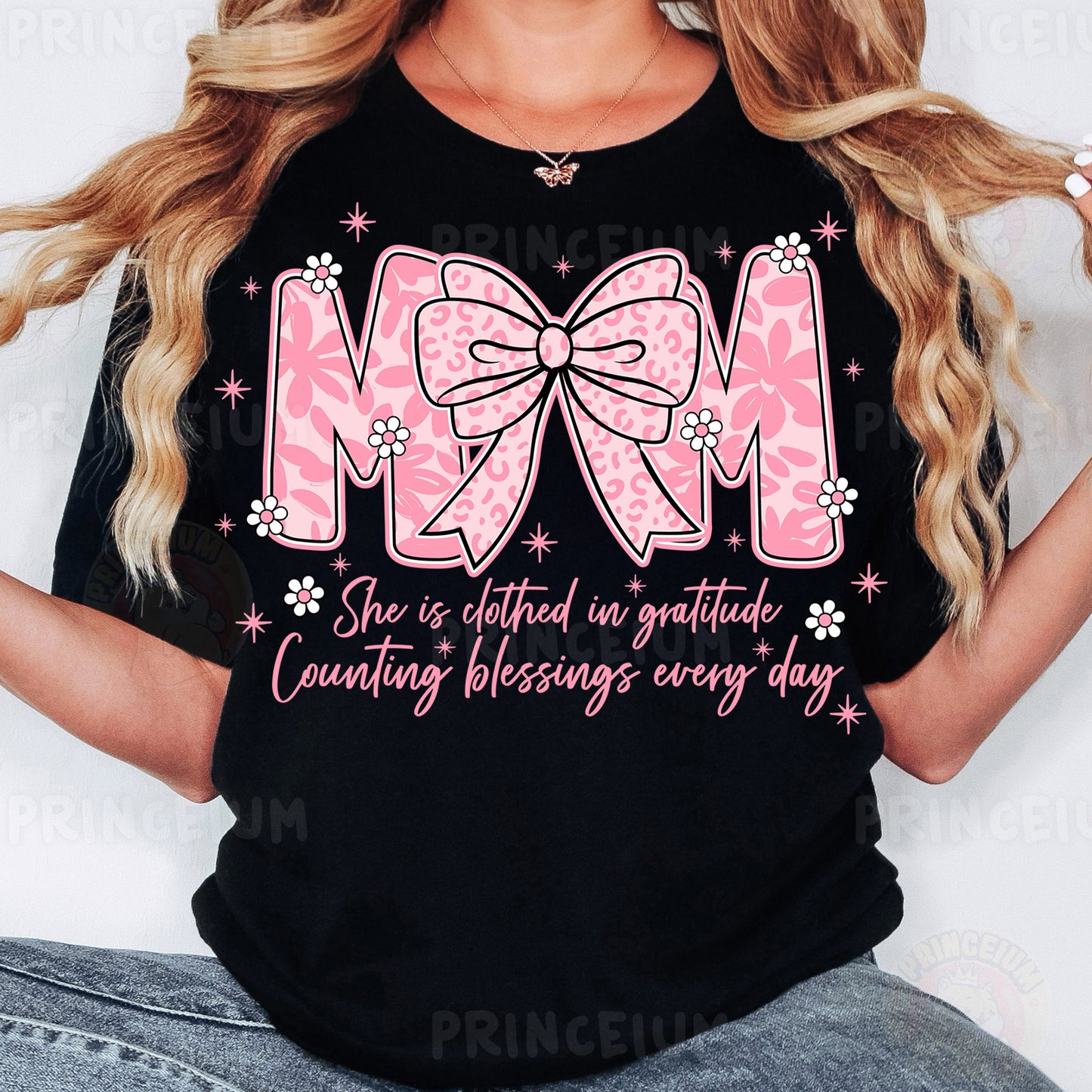 a woman wearing a black shirt with a pink bow