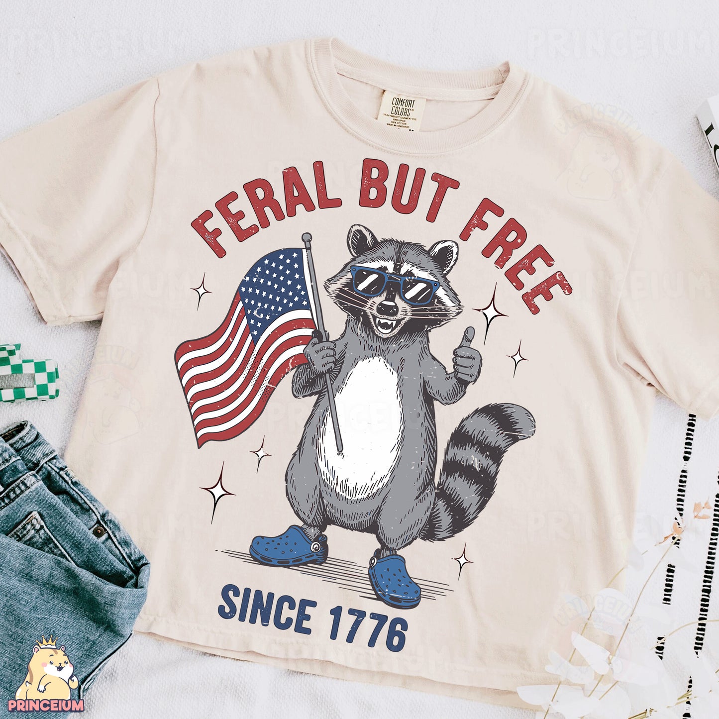 a t - shirt with a raccoon holding an american flag