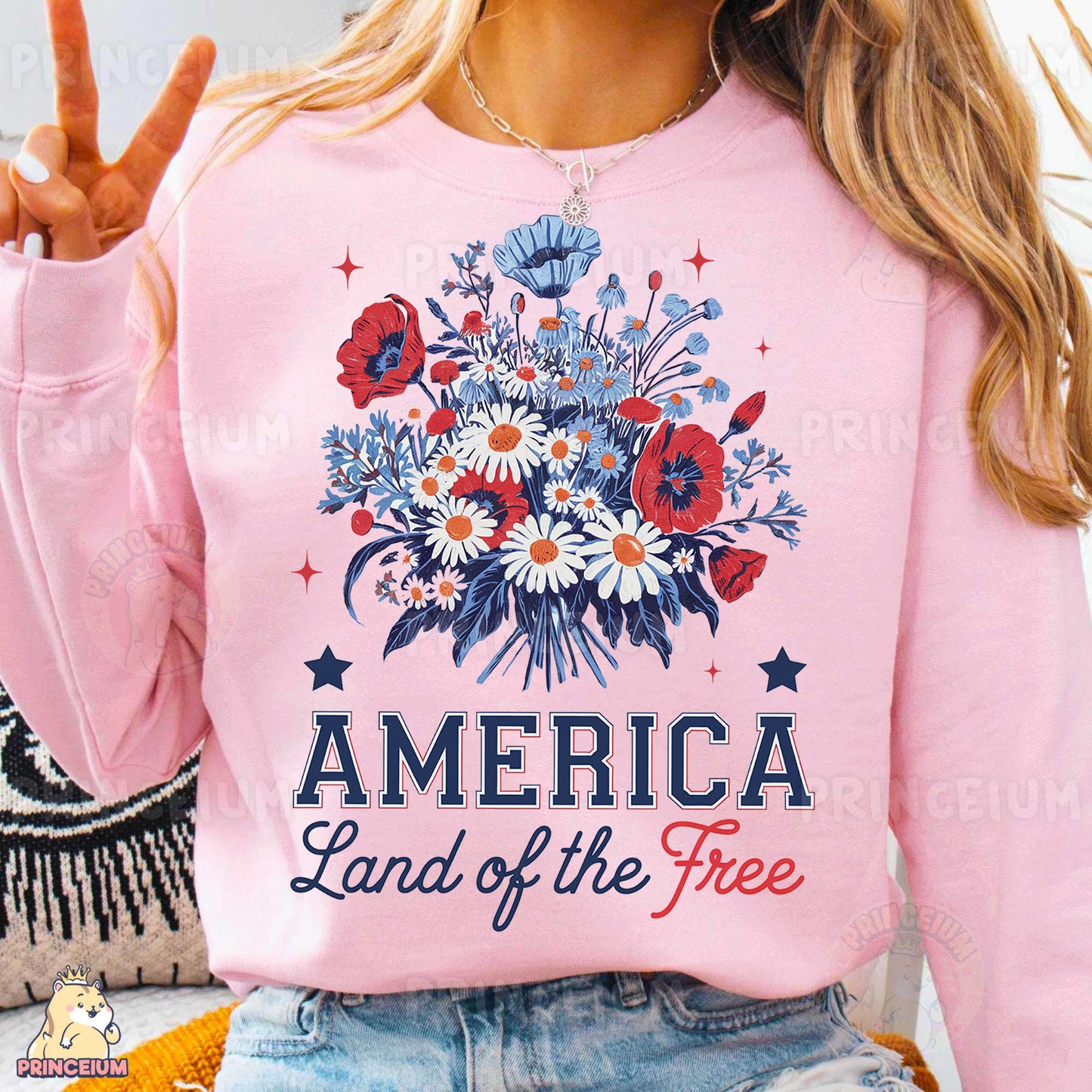 a woman wearing a pink america land of the free sweatshirt