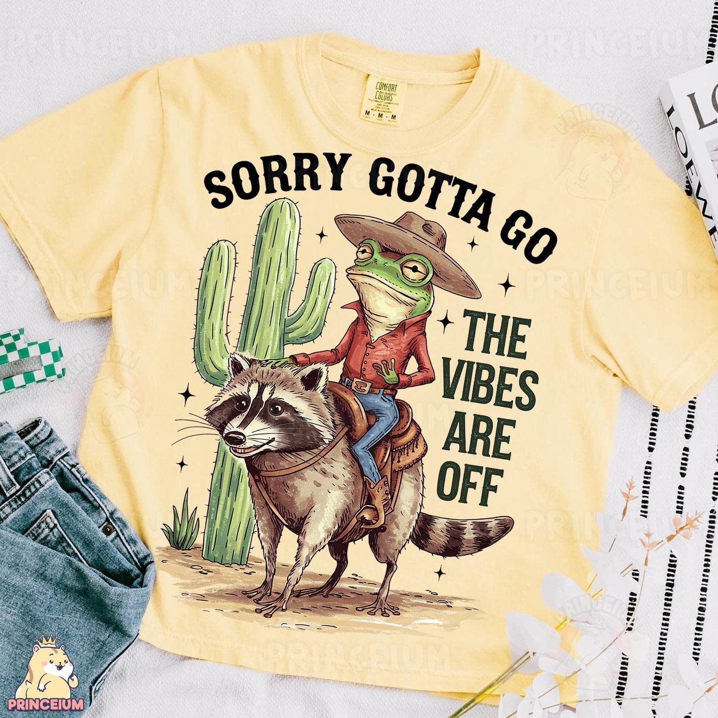 a yellow shirt with a raccoon riding on the back of it