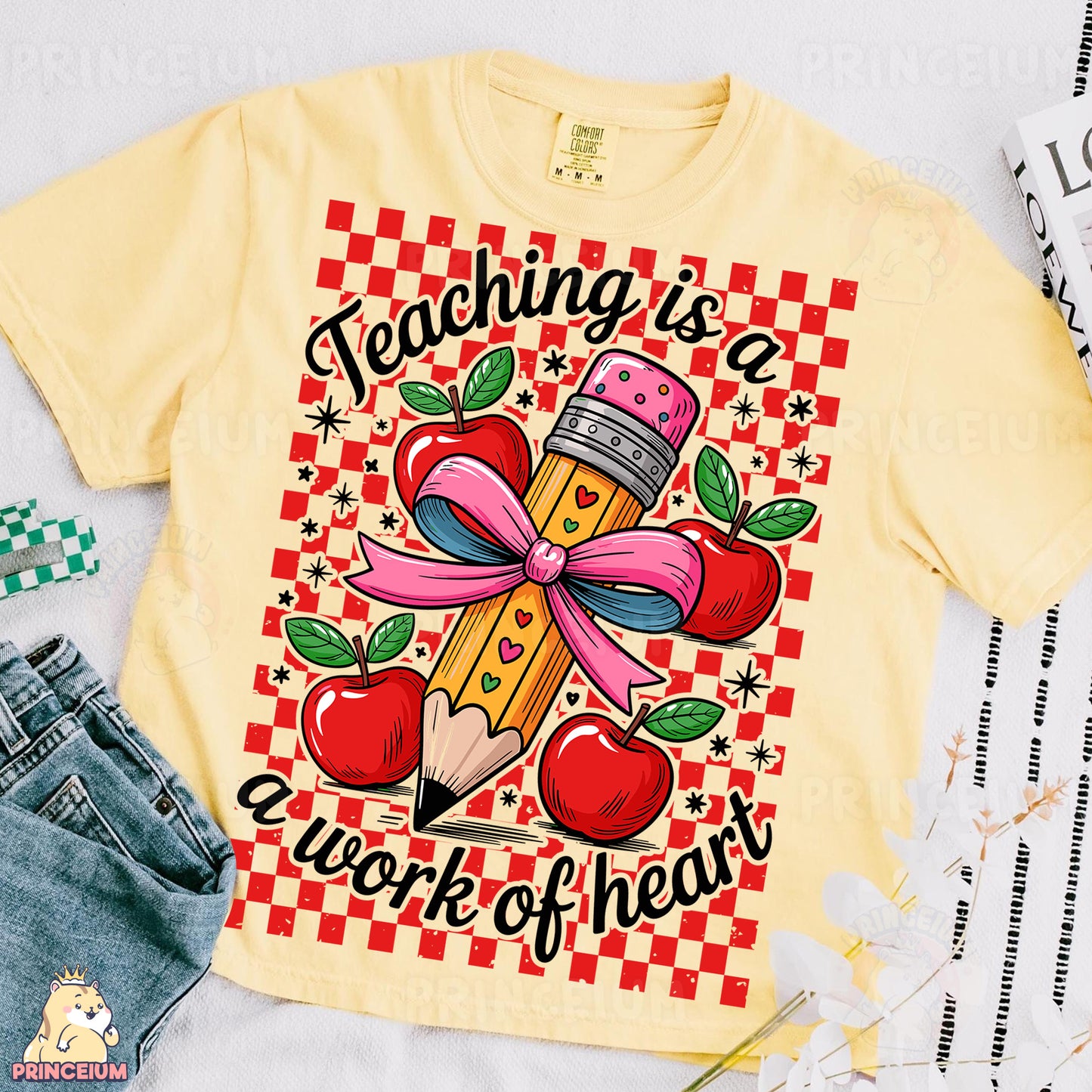 a t - shirt with a pencil and apple on it
