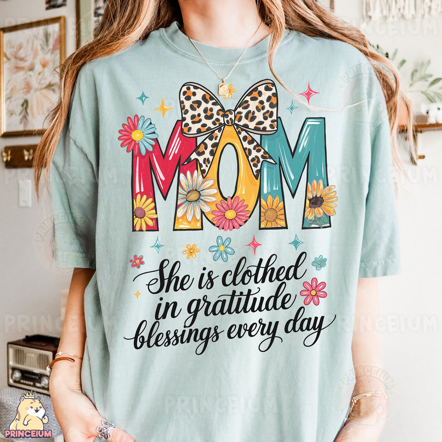 a woman wearing a t - shirt that says mom she is clothed in grati