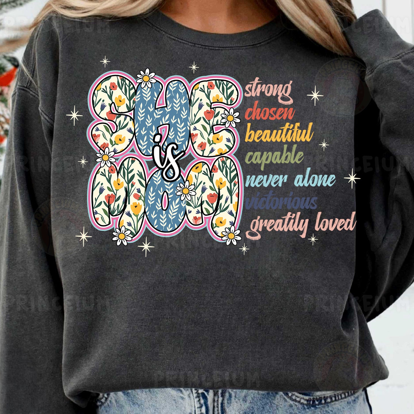 a woman wearing a black sweatshirt with a colorful flower design