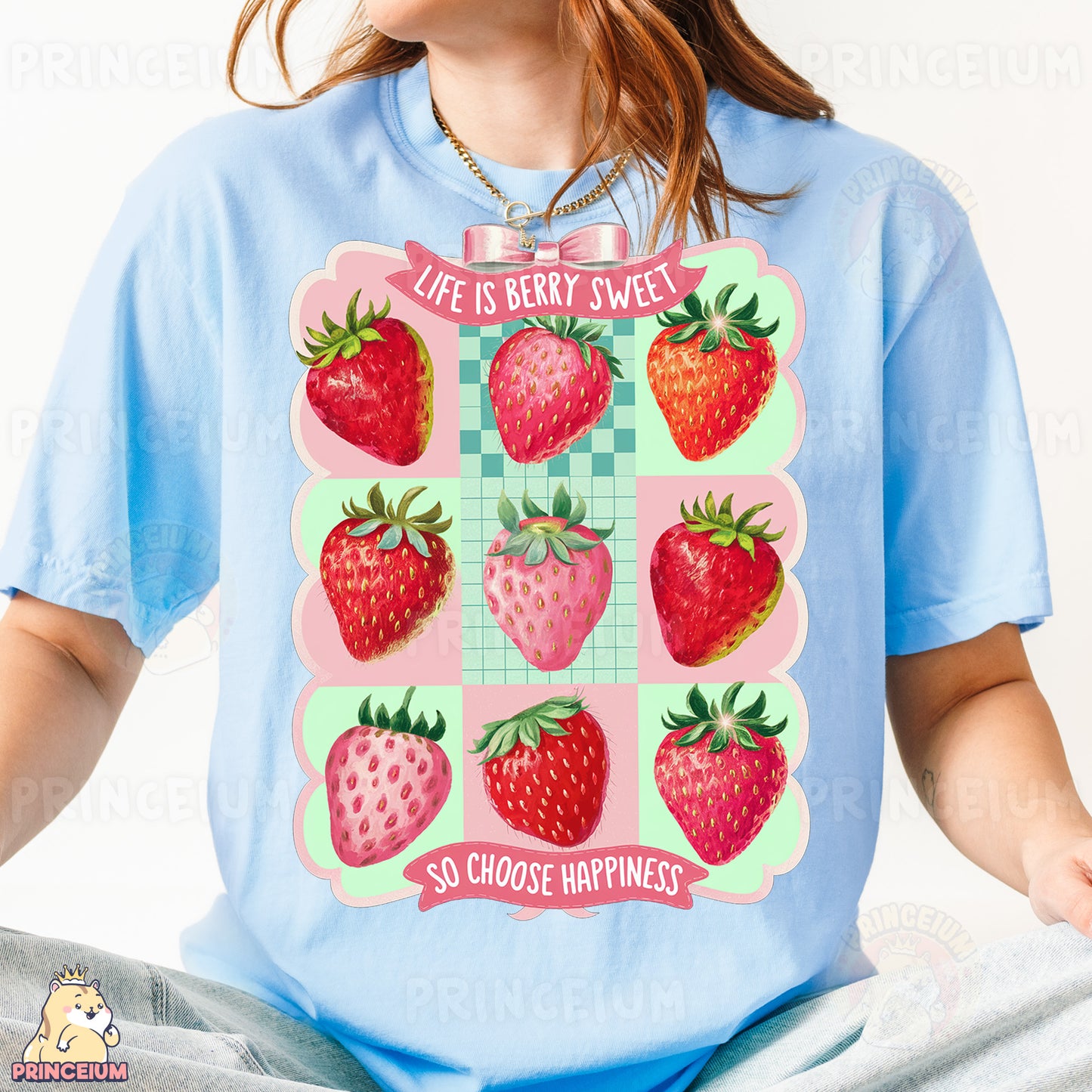 a woman wearing a blue shirt with a bunch of strawberries on it