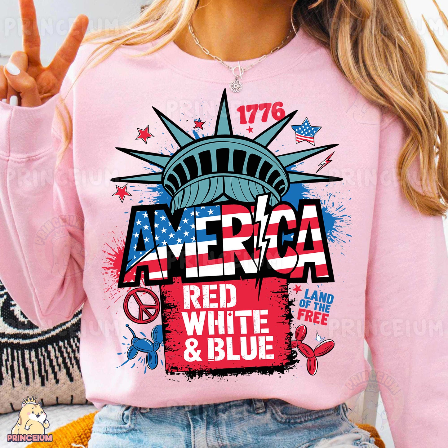 a woman wearing a pink sweatshirt with the statue of liberty on it