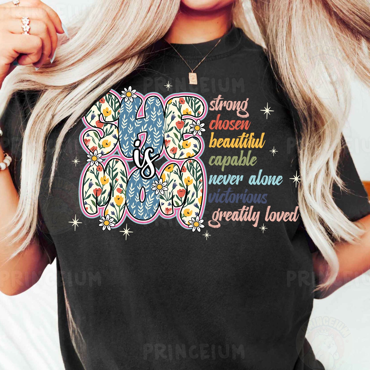 a woman wearing a black t - shirt with a flower design