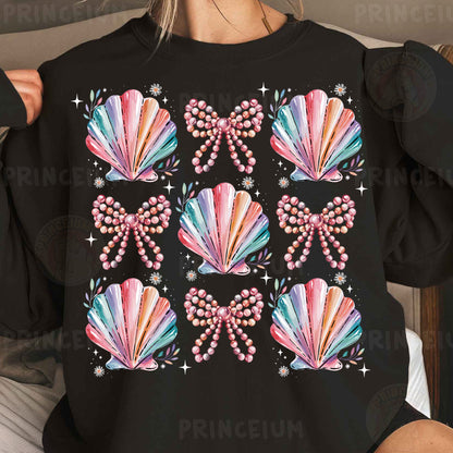 a woman wearing a black shirt with colorful seashells on it
