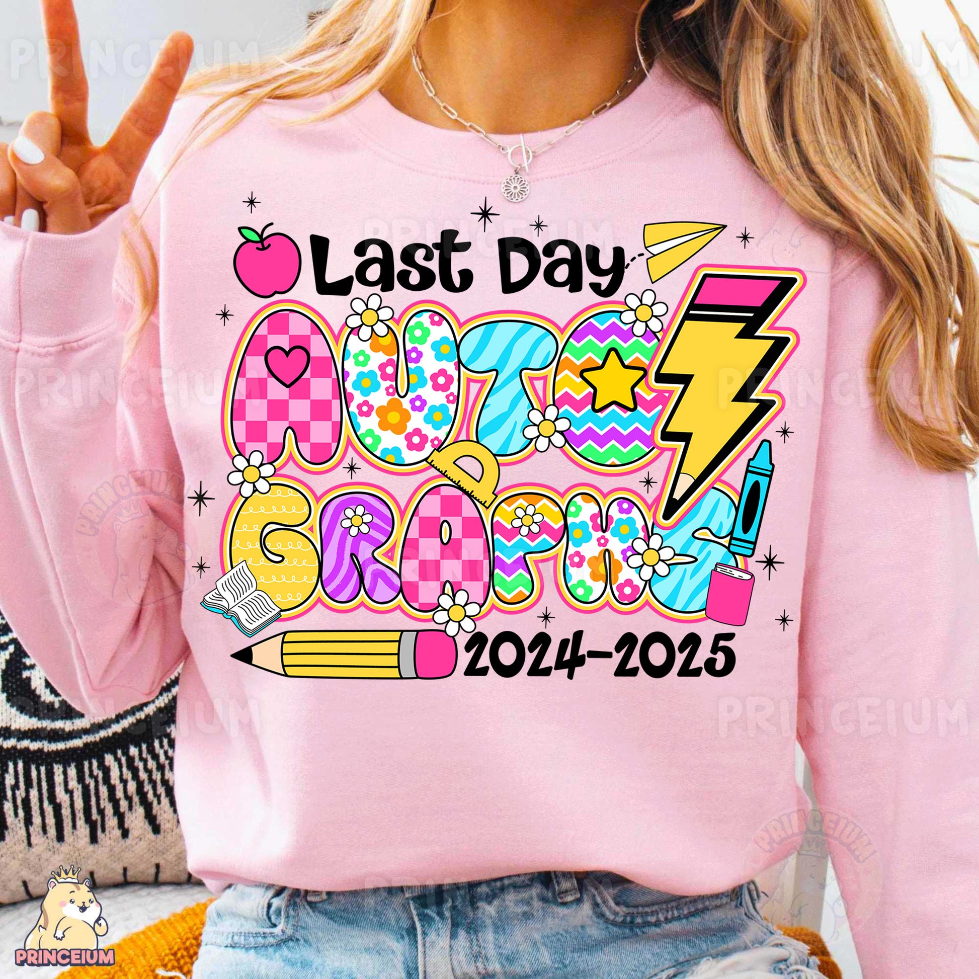 a woman wearing a pink sweatshirt with a back to school design