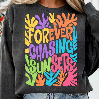 a woman wearing a sweatshirt that says forever chasing sunsets