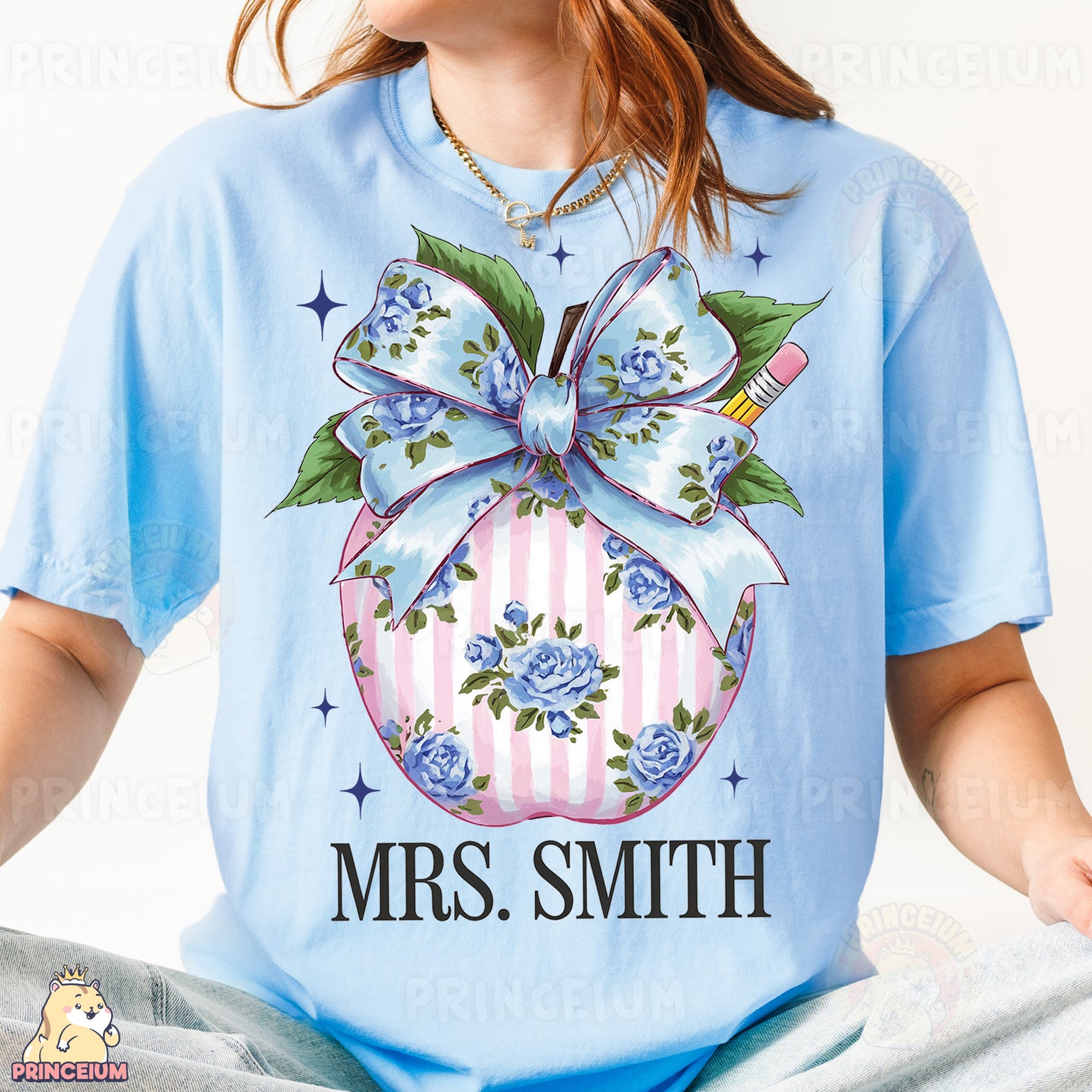 a woman wearing a blue t - shirt with a christmas ornament on it