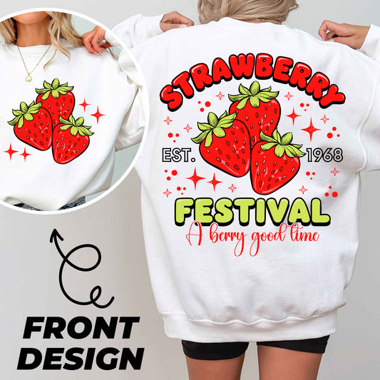 a woman wearing a white sweatshirt with strawberries festival on it