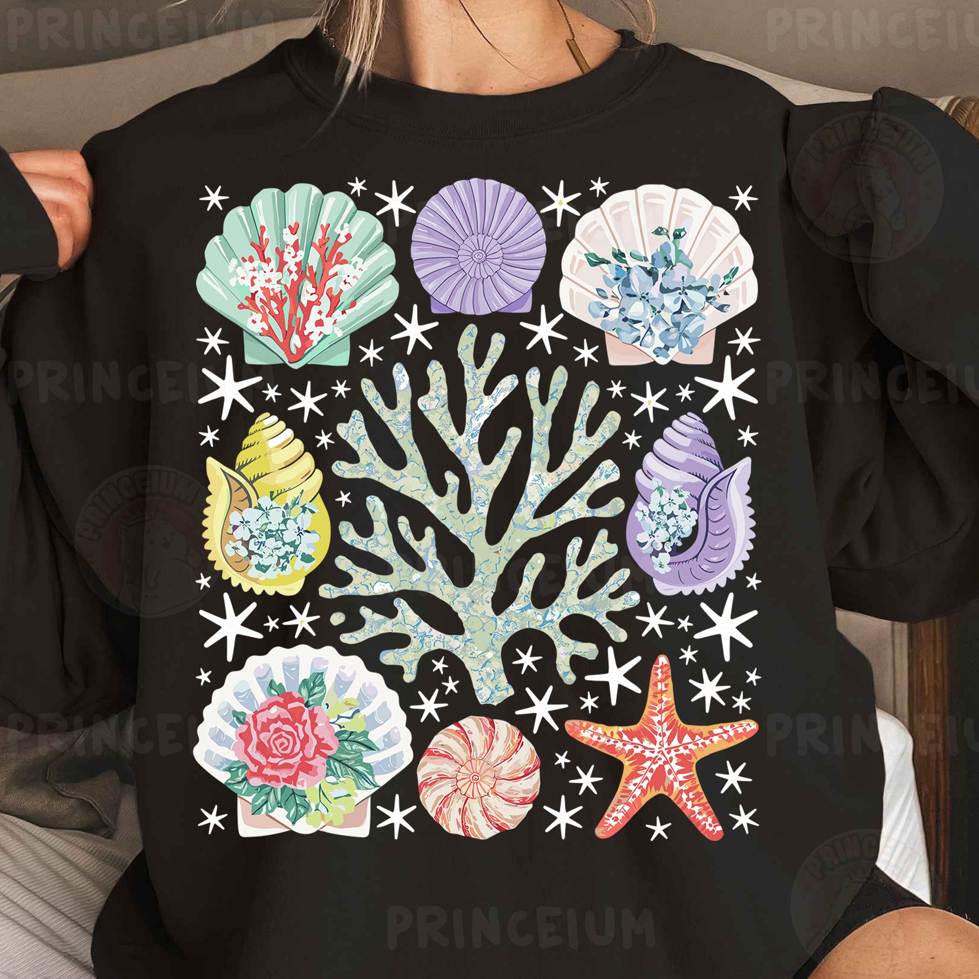 a woman wearing a black sweatshirt with colorful seashells on it
