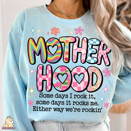 a woman wearing a sweatshirt that says motherhood