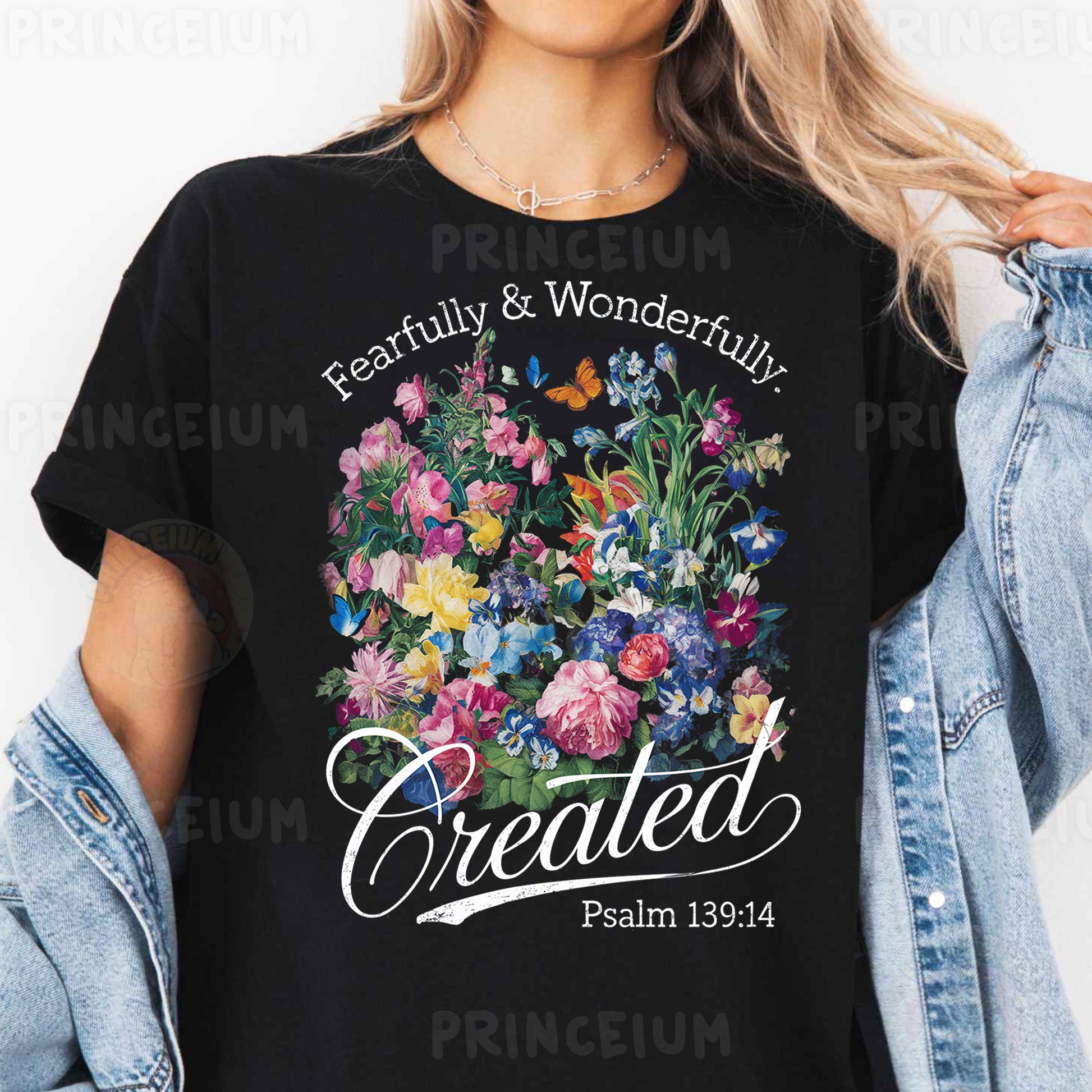 a woman wearing a black t - shirt that says created with flowers