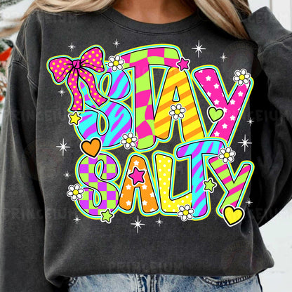 a woman wearing a sweatshirt that says stay salty