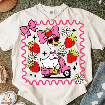 a t - shirt with a picture of a duck riding a scooter