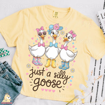 a yellow shirt with two ducks on it