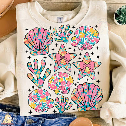 a t - shirt with a design of seashells and stars