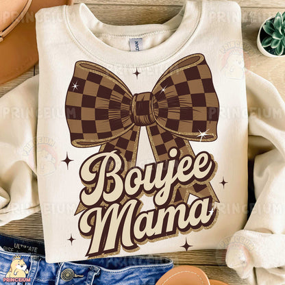 a t - shirt that says boyie mama with a bow on it