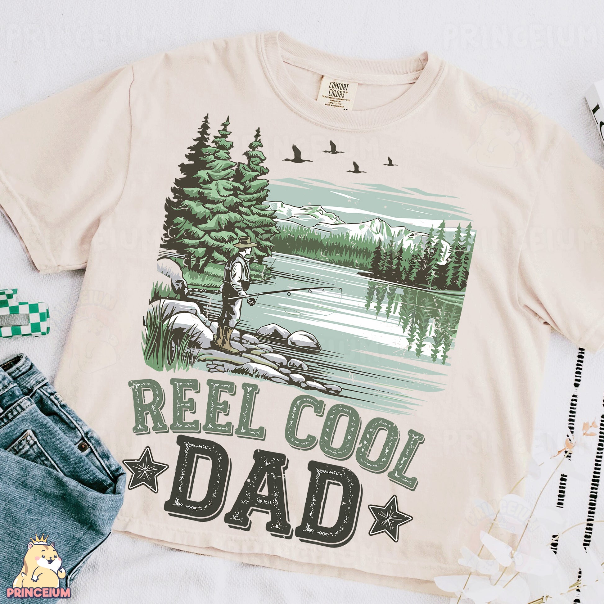 a t - shirt that says reel cool dad next to a pair of jeans
