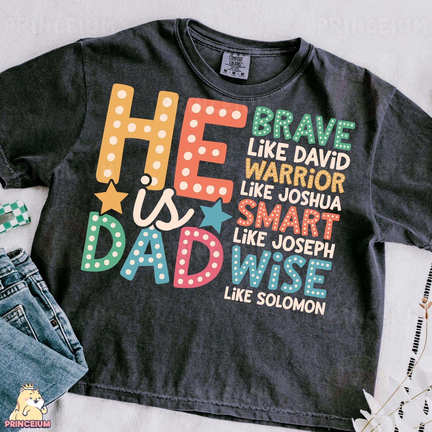 a t - shirt that says he is a dad and a pair of jeans