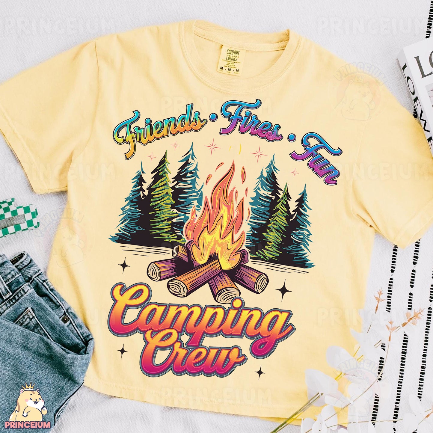 a yellow shirt with a campfire and trees on it